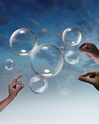 Hands bursting bubbles