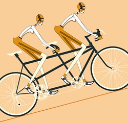 Women in sportswear riding tandem racing bicycle