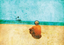 Man listening to headphones on deserted beach admiring the view