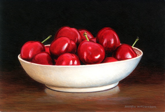 Red cherries in white porcelain bowl