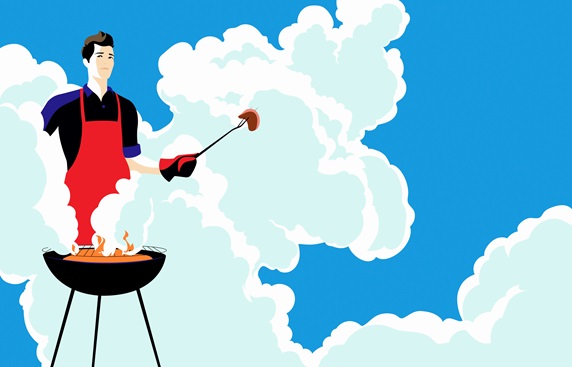 Young man barbecuing in clouds of smoke