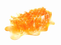 Honey oozing from sticky honeycomb
