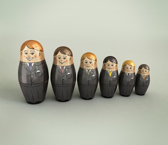 Businessmen nesting dolls in order of size and happiness