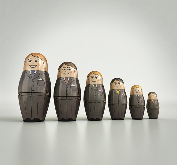 Businessmen nesting dolls in order of size and happiness