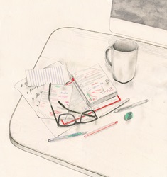 Notepad, pens and eyeglasses on desk