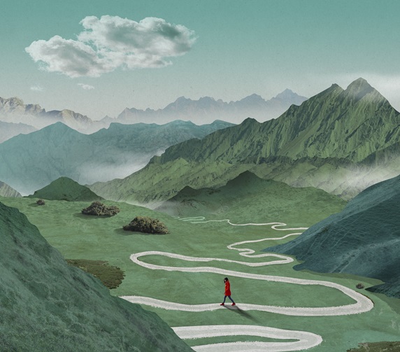 Woman in red coat walking on winding road in valley surrounded with green mountains