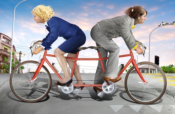 Businesswomen cycling in different directions