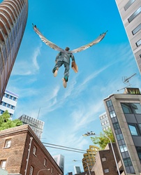 Successful businessman with wings flying over city
