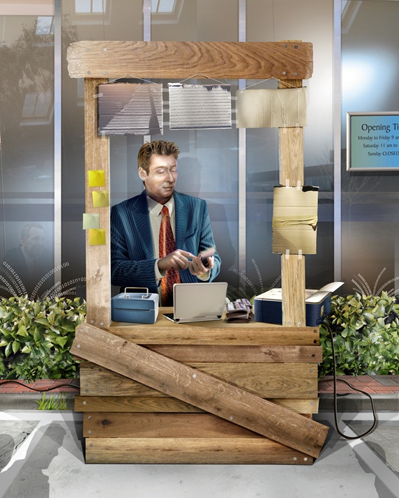 Businessman with laptop and mobile phone sitting in wooden office