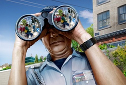 Police officer looking through binoculars