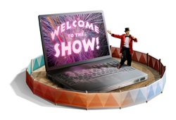 Male host next to laptop with welcome to show on screen in circus