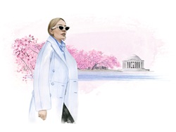 Elegant woman walking in front of blooming cherry trees and Jefferson Memorial