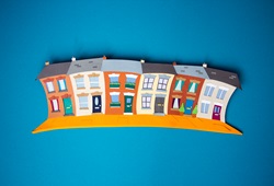 Paper houses on blue background