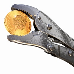 Pliers holding British one pound coin