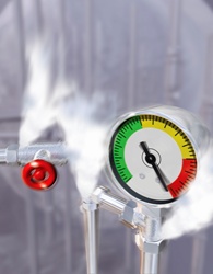 Steam pressure escaping from pipes with pressure gauge warning