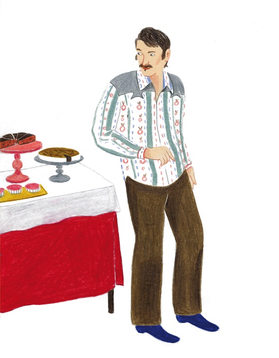 Man standing by table with cakes