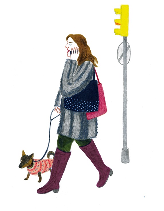 Woman using phone while walking dog