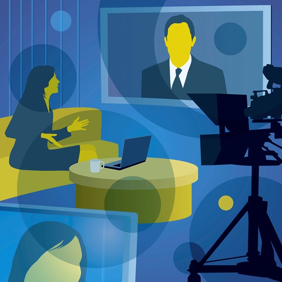 Woman interviewing man on visual screen in television studio