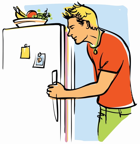 Young man looking into fridge