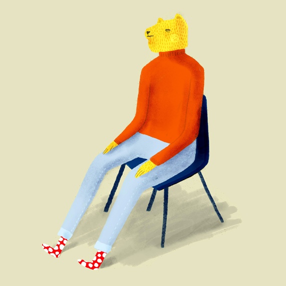 Person with cat's head sitting on chair