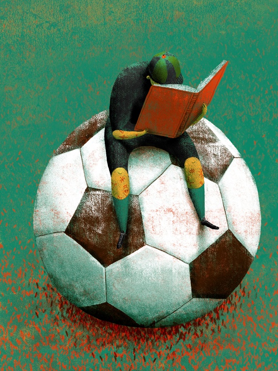 Girl sitting on giant soccer ball and reading book