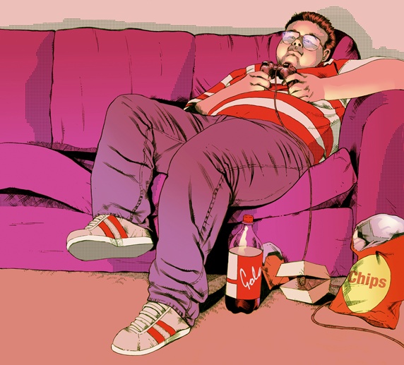 Overweight teenage boy on sofa playing on games console