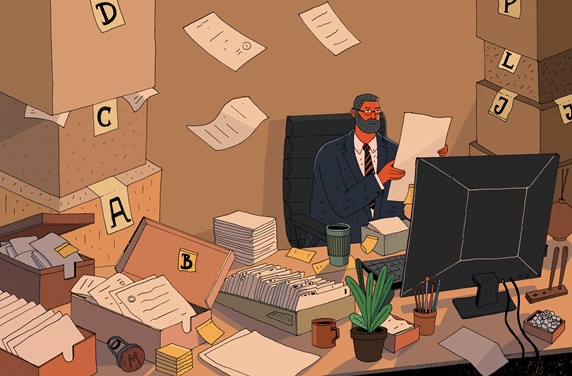 Overworked businessman with piles of paper