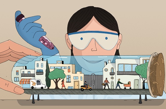 Scientist with vial in hand looking at city scene in large laboratory vial