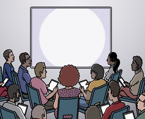Group of people looking at blank projection screen
