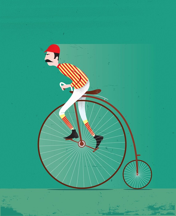 Old-fashioned cyclist on penny farthing bike