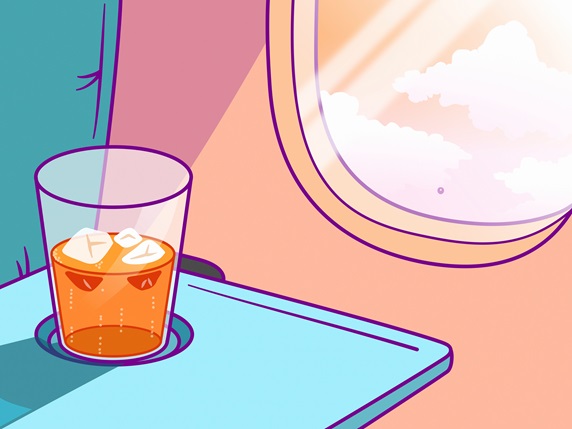 Close up of drink on tray beside aeroplane window