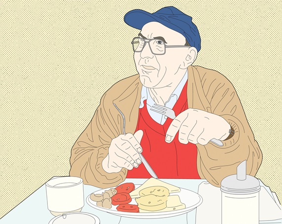 Mature man eating in diner