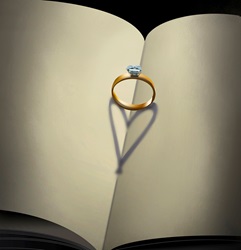 Engagement ring with heart shaped shadow on open book