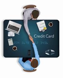 Overhead view of businessmen shaking hands over credit card desk