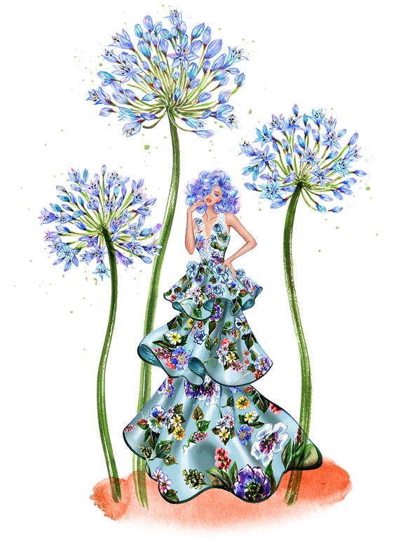 Woman wearing floral dress standing amongst blue flowers
