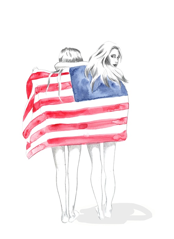Two women wrapped in American flag