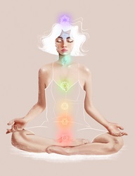 The seven Chakra symbols over young woman meditating