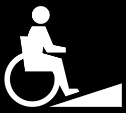 Person in wheelchair moving up ramp