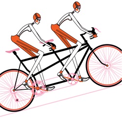 Two women cycling tandem bicycle
